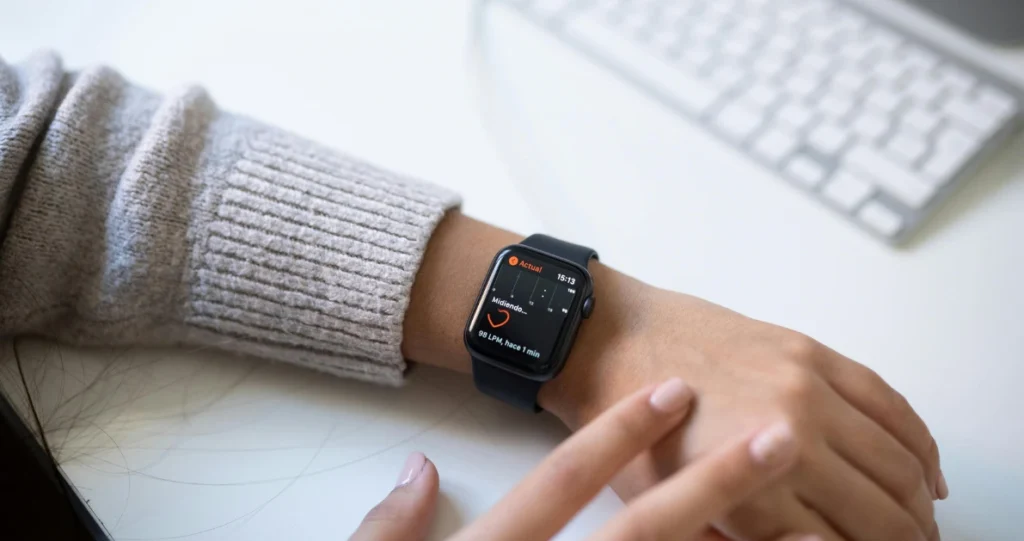 Smartwatch displaying heart rate data on wrist for vital sign monitoring